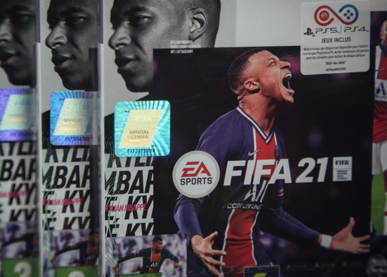Copies of the FIFA 2021 soccer game, produced by Electronic Artists Inc., for the PlayStation 4 (PS4) console at a video games store in Paris, France, on Thursday, June 17, 2021. The reinstatement of Cyberpunk 2077 to the PlayStation store will help CD Projekt SA with the marketing of games series but may not make much of a difference for its bottom line until a new version of the futuristic role-playing game is ready, according to BOS Bank SA analyst Tomasz Rodak. Photographer: Cyril Marcilhacy/Bloomberg