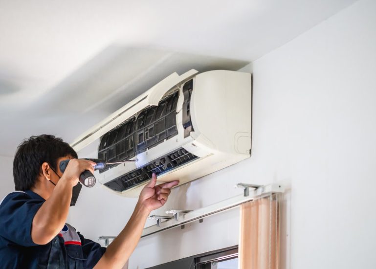 male-technician-using-screwdriver-fixing-modern-air-conditioner-male-technician-cleaning-air-conditioner-indoors-maintenance-repairing-concepts-1